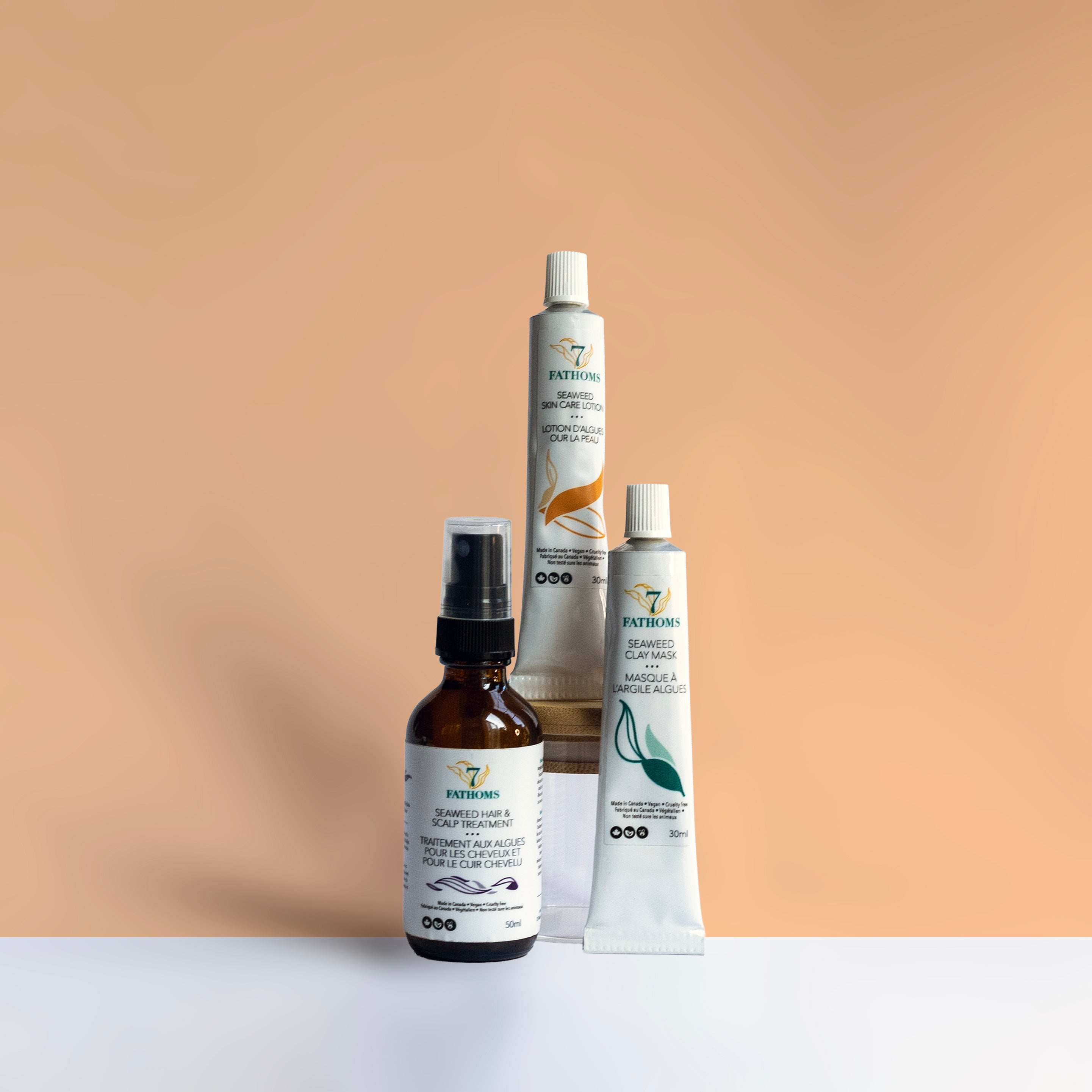 Set of skincare products with labels on a peach background