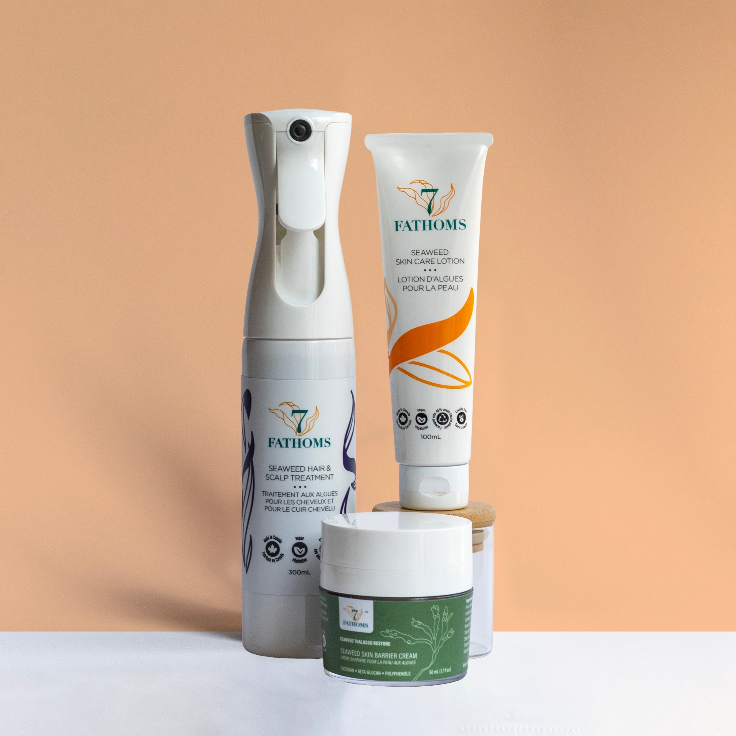 Three Fathoms skincare products on a peach background.