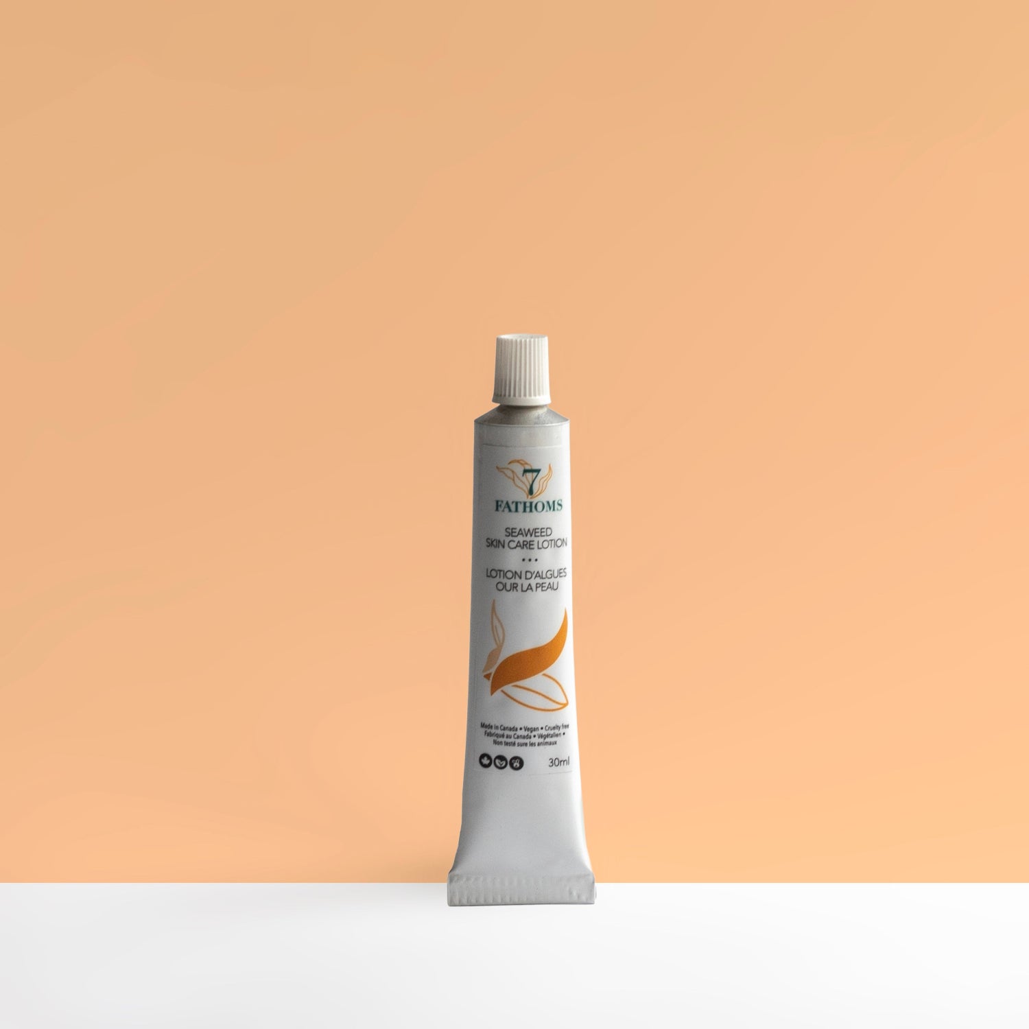 Tube of skincare product on a peach background