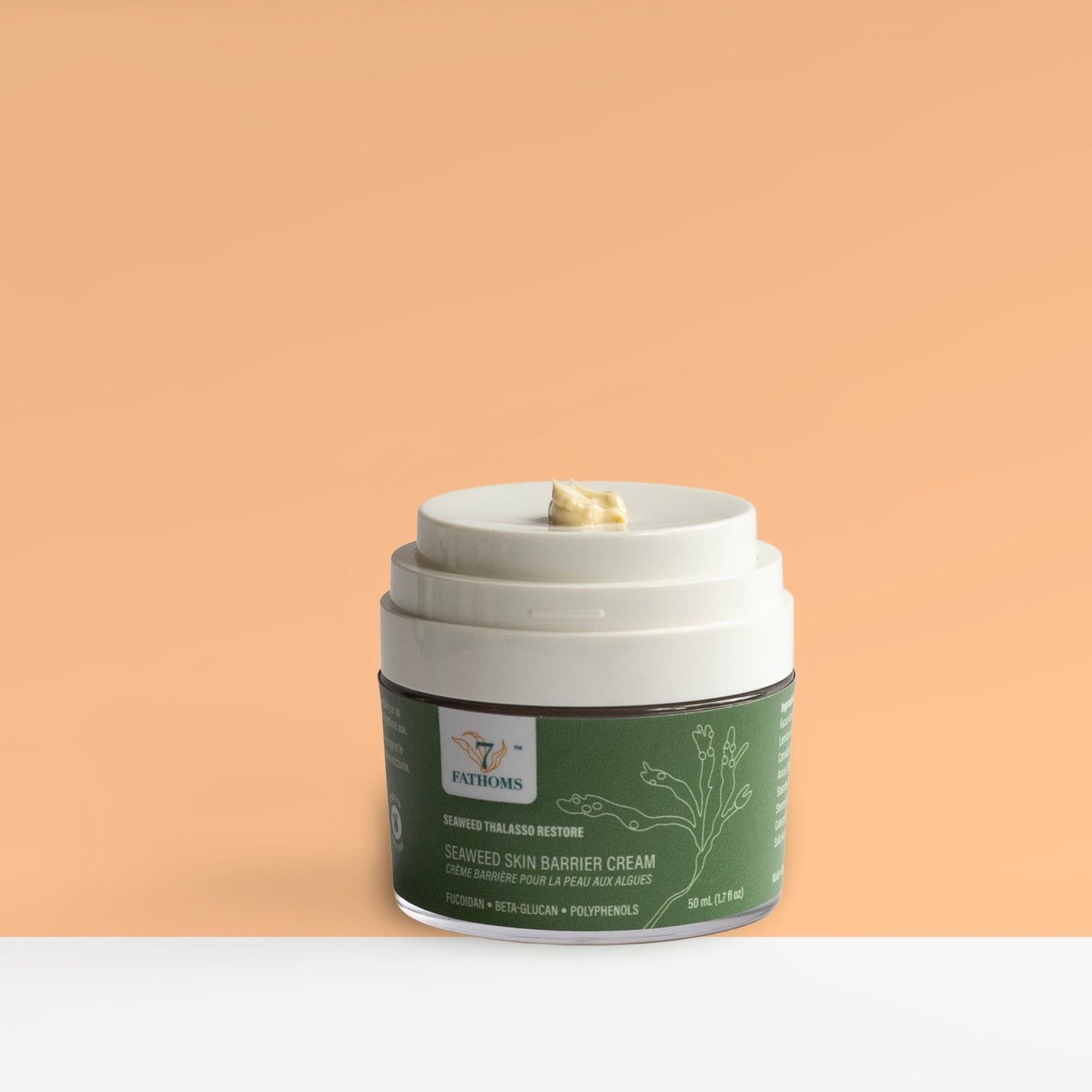 Jar of Thalasso restore with green label on a peach background