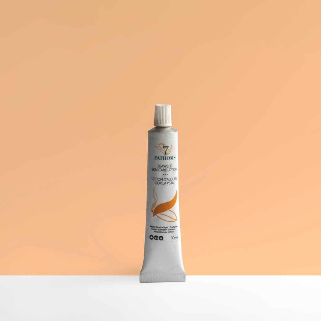 Tube of skincare product on a peach background